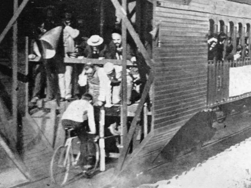 Charles Murphy riding a mile in under a minute drafting behind a train, 1899.